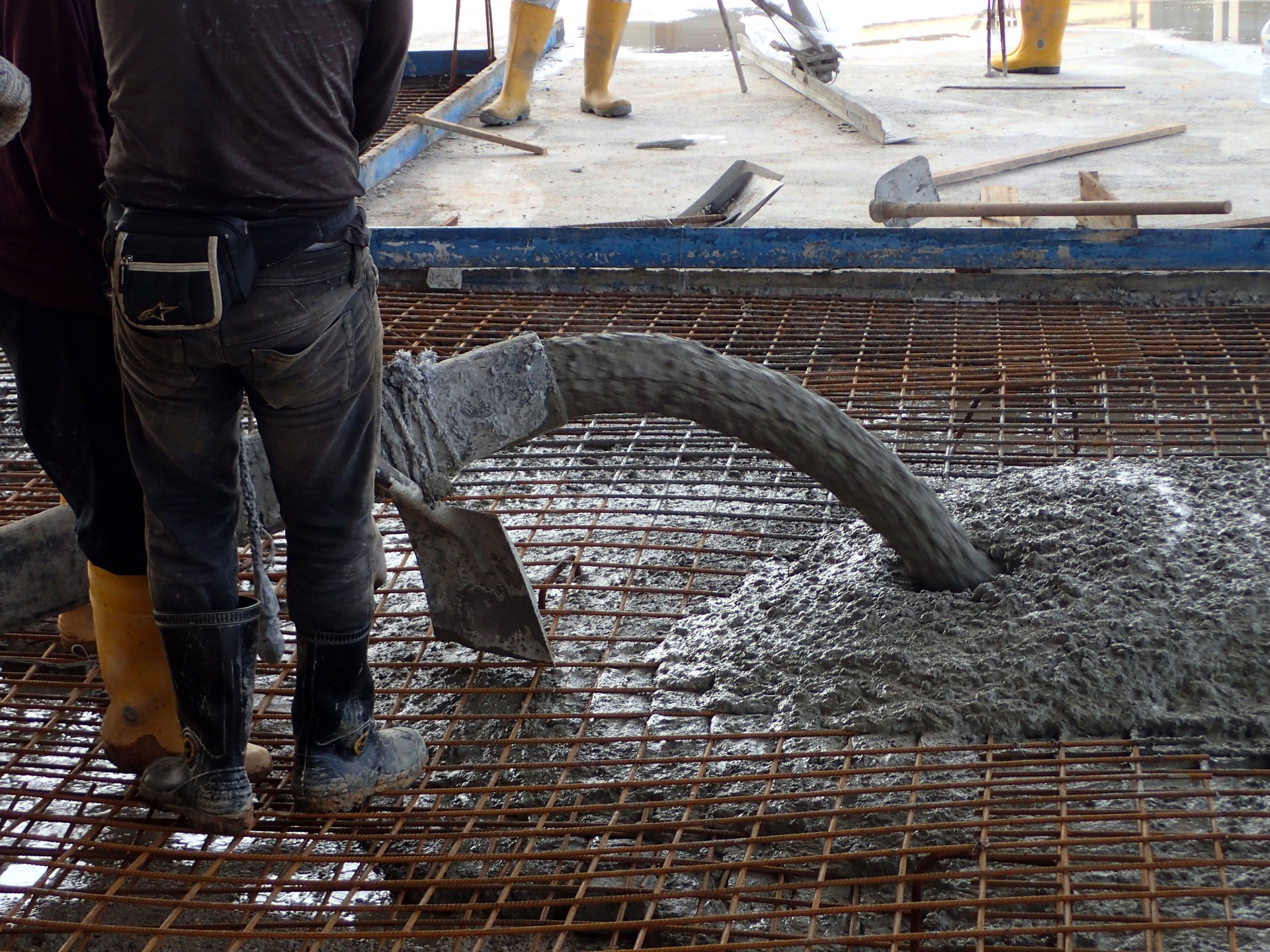 Construction worker pouring concrete  for a building floor slab