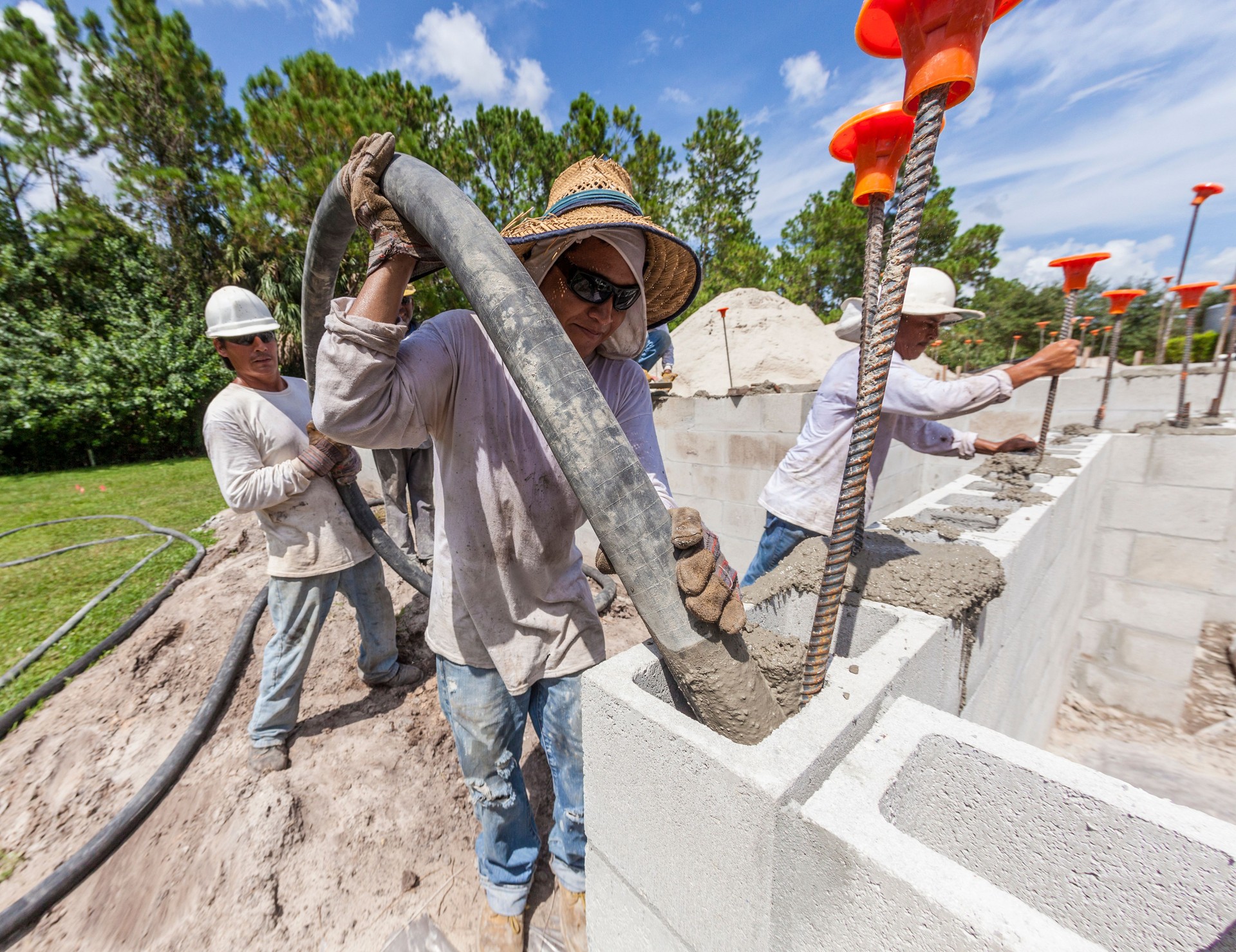 Construction Workers Pouring Concrete on Job Site